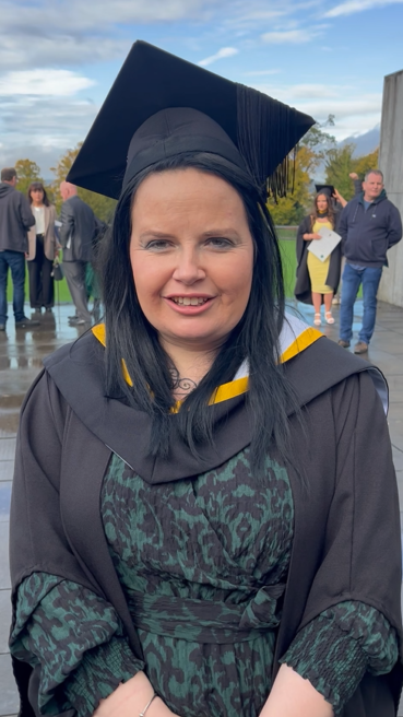 Mature student on graduation day in cap and gown.