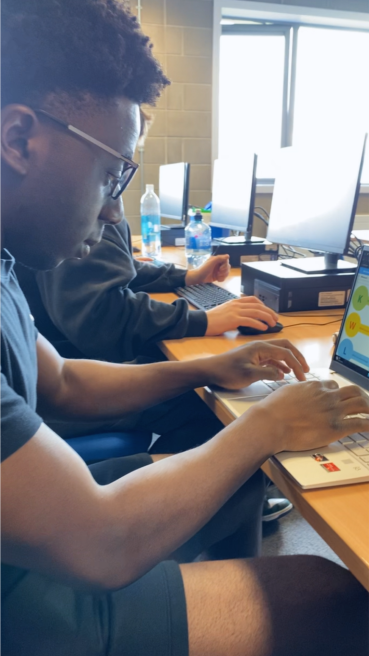 Student sitting at laptop typing