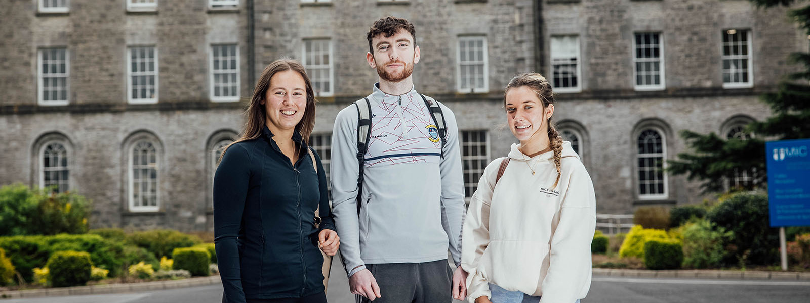 Three students standing outside MIC Thurles campus