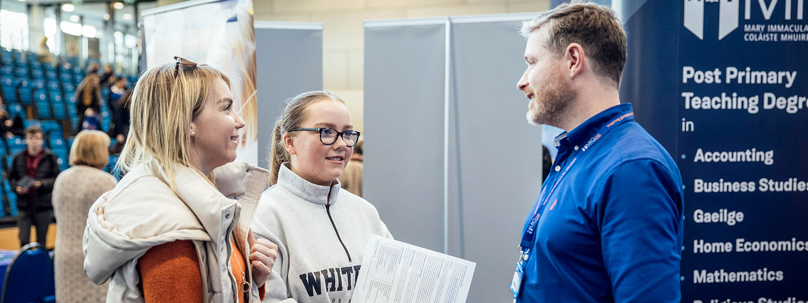 MIC staff member talking to MIC October Open Days event attendees.