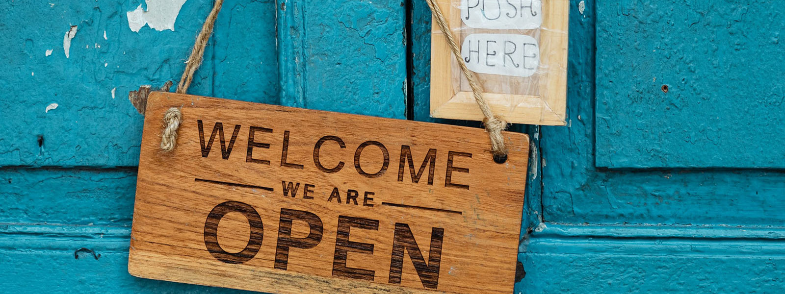 We are open sign on a blue door