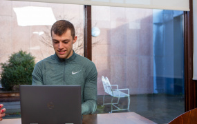 MIC student sitting at laptop