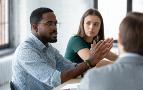 Three students talking at a table