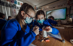 Two female students partaking in science experiment