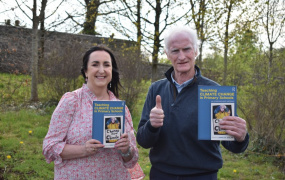 Dr Anne Dolan and Duncan Stewart holding the Teaching Climate Change in Primary Schools