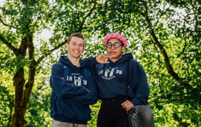 Two MIC students standing in front of trees