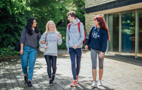 Four students walking and talking