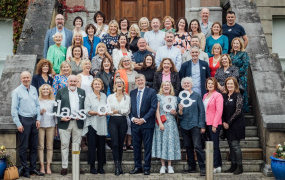 Group shot of the Class of 1988 standing on the front steps of MIC