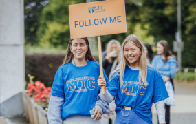 2 MIC Campus Ambassadors leading students on a tour of the college