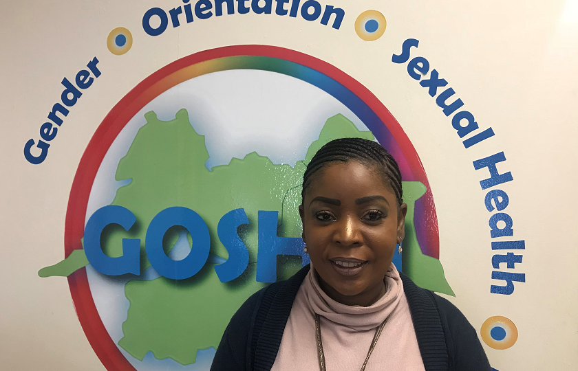 Ann Piercy from GOSHH (Gender, Orientation, Sexual Health, HIV) pictured in front of the GOSHH logo