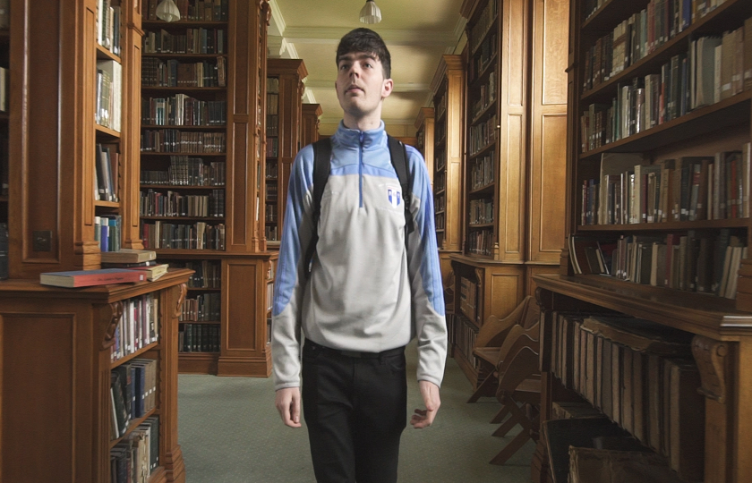 MIC student walking through library