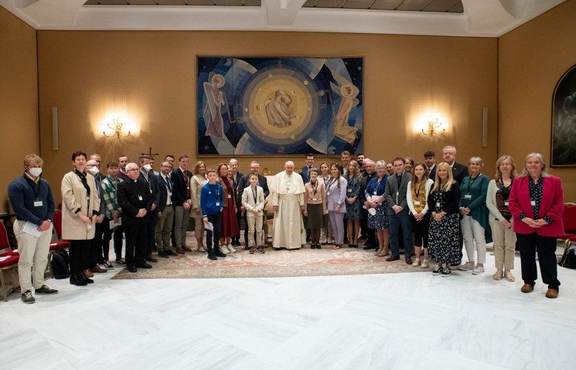 GRACE educators standing either side of Pope Francis in the Vatican