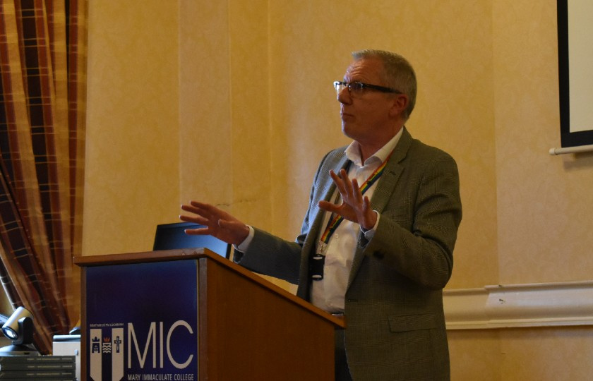 Professor William Leahy speaking at a lecture stand