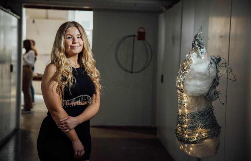 Amy Tobin standing beside half mannequin with chains around it