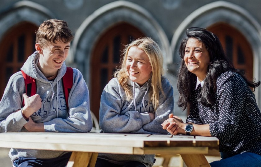 Students sitting at a table and laughing