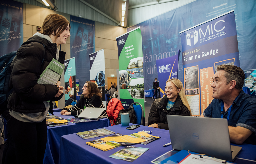 Two lecturers talking to student at Open Day event