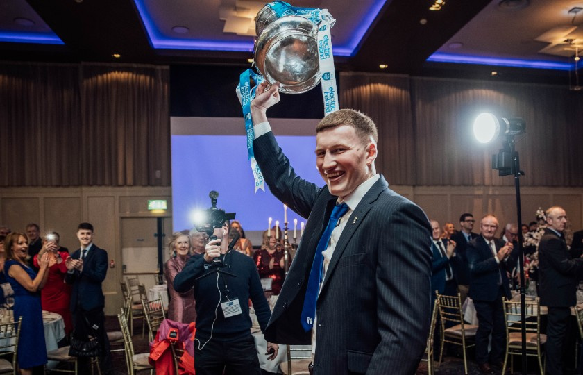 Captain Colin O'Brien lifts the trophy over his head in front of the crowd