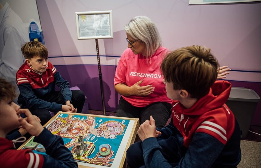 A volunteer from Regeneron with pupils from An Mhodhscoil Limerick at the launch of the Regeneron Future Scientist Exhibition in Mary Immaculate College