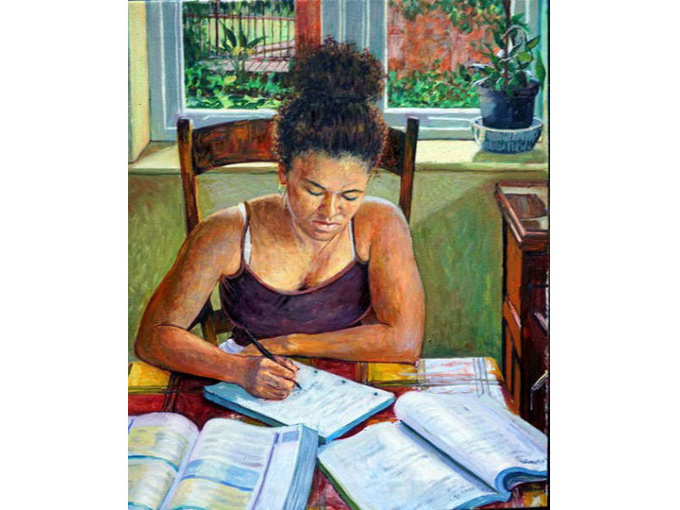 Girl studying with open books in front of her