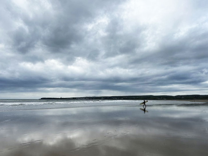 Surfer alone on the beach