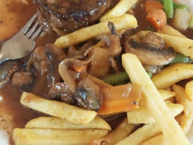 Traditional meat and veg dinner with chips on a white plate